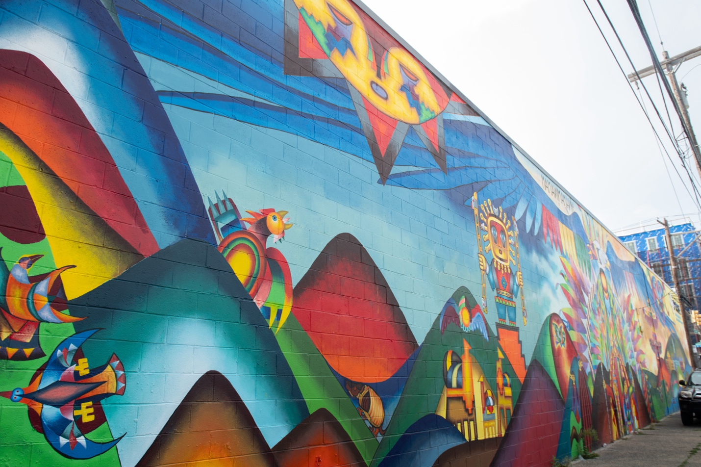 Beautiful birds, an armadillo or quirquincho and llamas, on the Andean side of the mural. Photo by Erin Blewett.