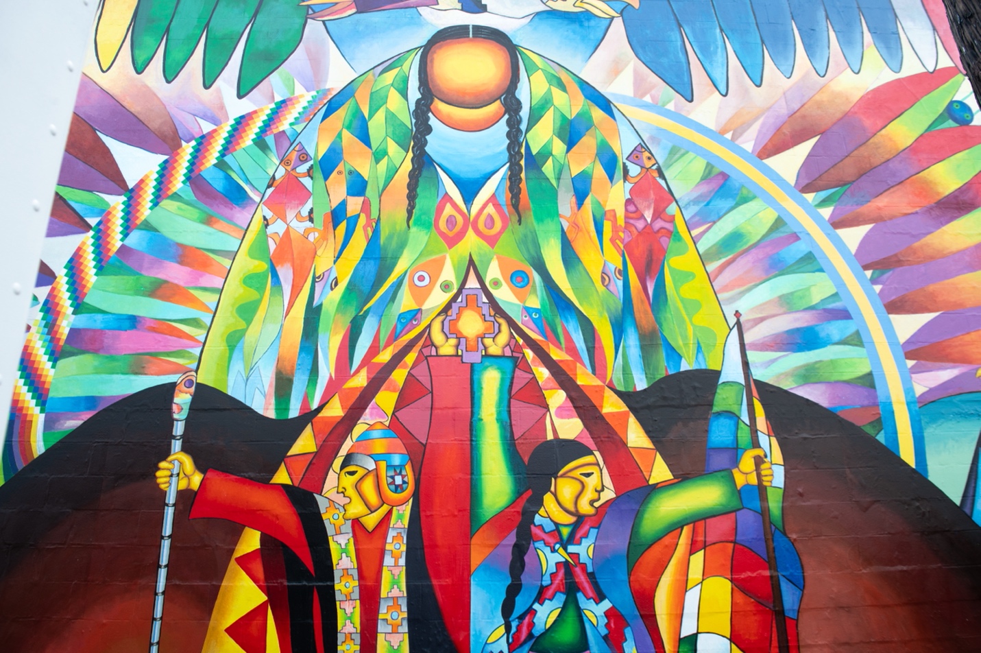 The Pachamama as depicted by Roberto Mamani Mamani. She is painted in the center of the mural, representing the powerful force of Mother Earth. Photo by Erin Blewett.