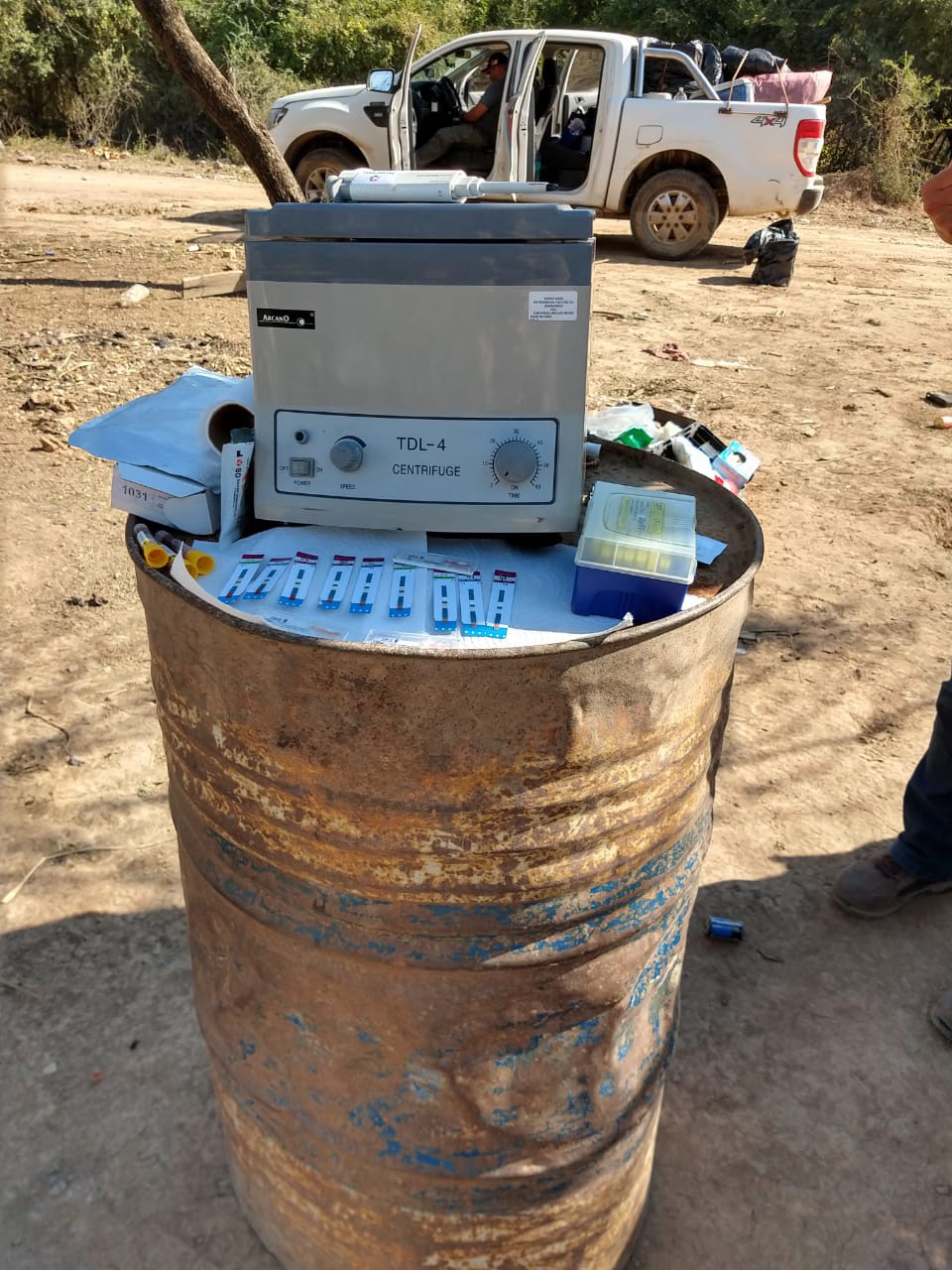 Portable “lab” setup with rapid tests and mobile unit pick-up truck in the background, El Toro community in Salta, Argentina. Photograph by Santiago L. Cunial, August 2019.